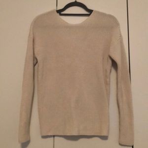 White sweater. Crew neck front, bow on back